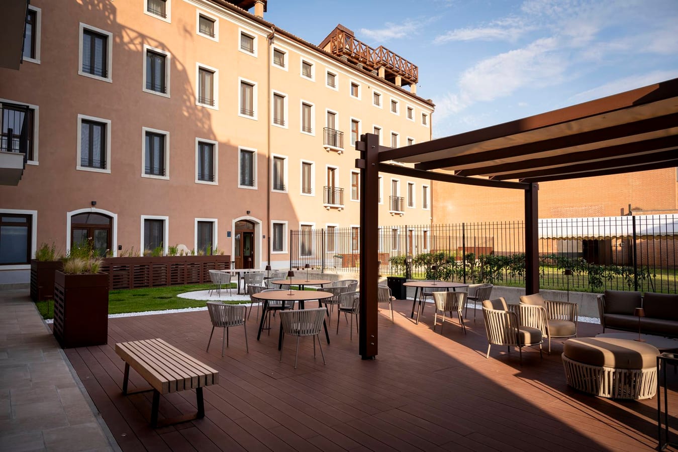 View of the outdoor garden with armchairs and tables of Palazzo dei Guardiani, Venice